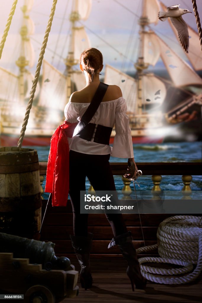 Pirate Girl Attack pirate captain in sexy clothes calmly stands on the deck of her ship under enemy fire and waits for an opportunity to attack 2015 Copenhagen Shootings Stock Photo