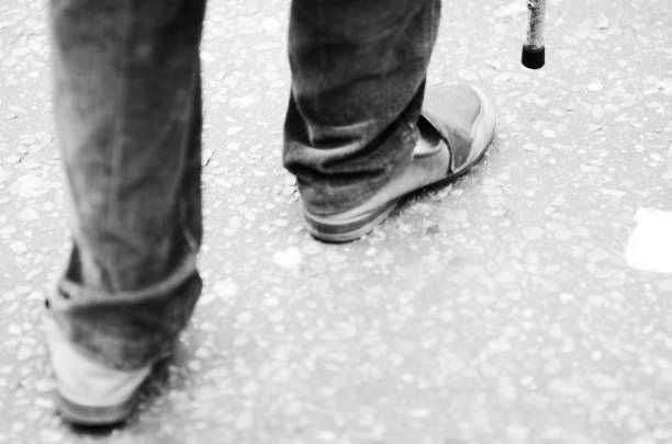 istock Feet Walking with Cane on the Street 866621078