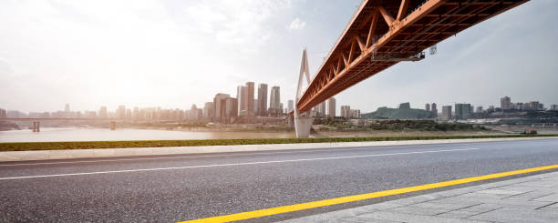istock empty asphalt road with modern bridge and buildings 866625144