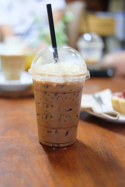 istock Ice cocoa with whipping cream on wood table 866626622