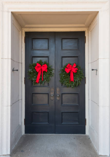 istock Two Christmas Wreaths on Building Doors 866629402
