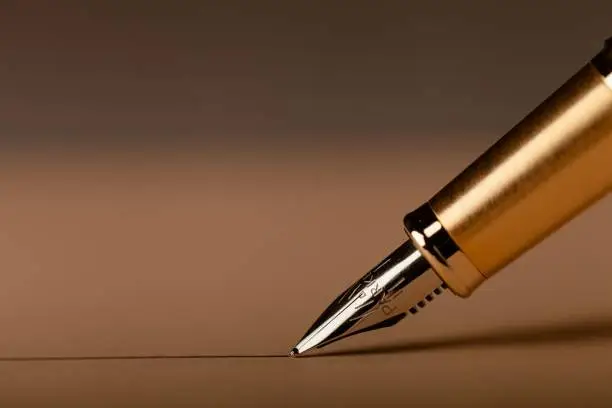 Parker Fountain Pen Draws a Straight Line on the Brown Background