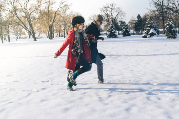 istock Couple running in winter forest 866637022