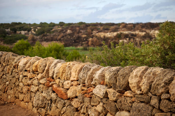 soft focus stone walls of ancient medieval castle ruins on top of rock in highland mountain landscape environment