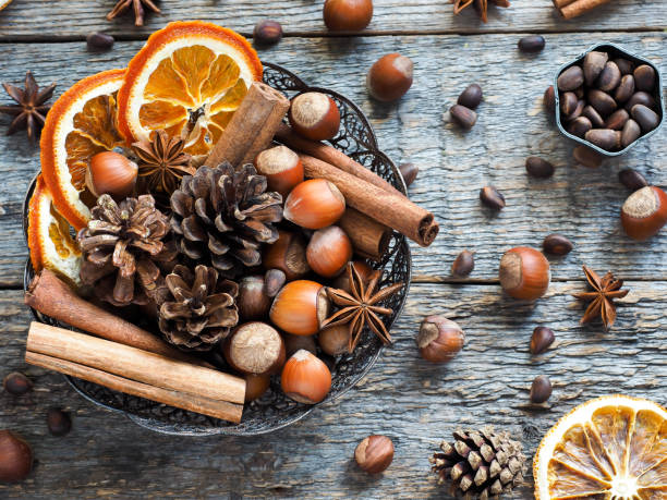 istock Winter ingredients nuts, cones, oranges, cinnamon star anise in a bowl. Rustic style 866644056