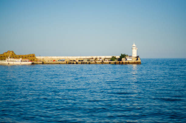 Wharf and lighthouse on the sea day nature