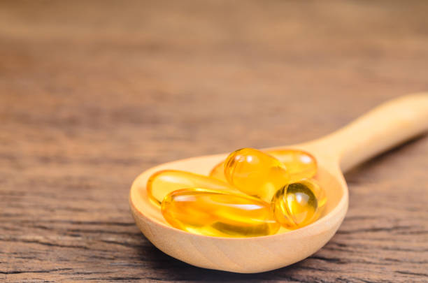 istock fish oil in wooden spoon 866647558