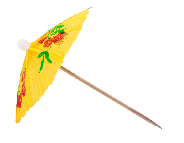 gelben regenschirm für einen cocktail - drink umbrella stock-fotos und bilder