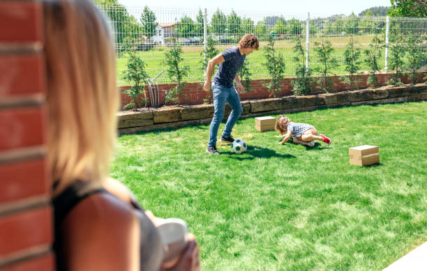 istock Mother watching her husband and son playing 866648428