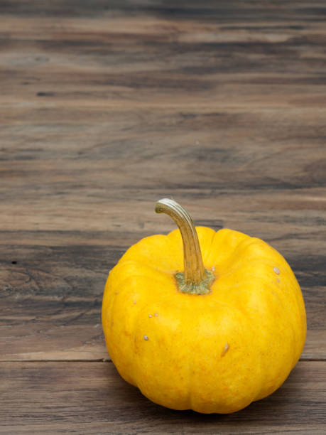 istock Yellow organic pumpkin on dark wooden background 866652448
