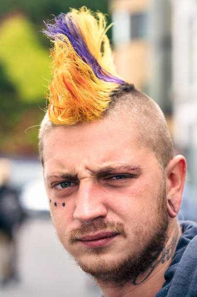 Portrait of London Punk in Camden Town Model released image - a portrait of a punk with a colourful mohican haircut, taken in Camden Town, London. skinhead haircut stock pictures, royalty-free photos & images