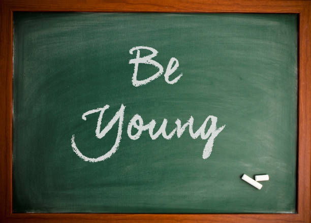 istock Be young  - Motivational quote on blackboard 866653098