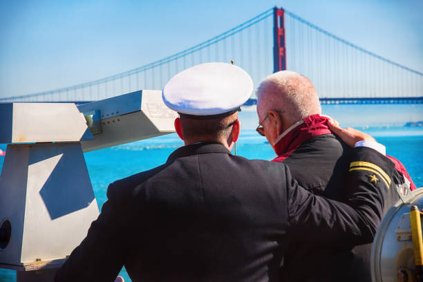 San Francisco, United States - October 6, 2017:  An active duty naval officer with his arm on the shoulder of his father, a navy veteran, while aboard the USS Essex in the Parade of Ships during Fleet Week 2017.