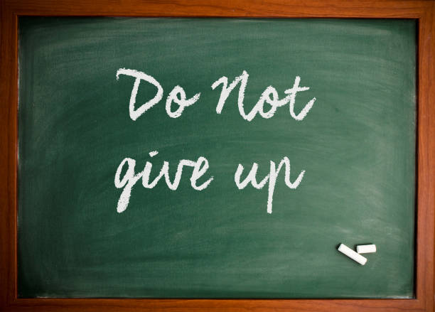 istock Don't give up  - Motivational quote on blackboard 866656910