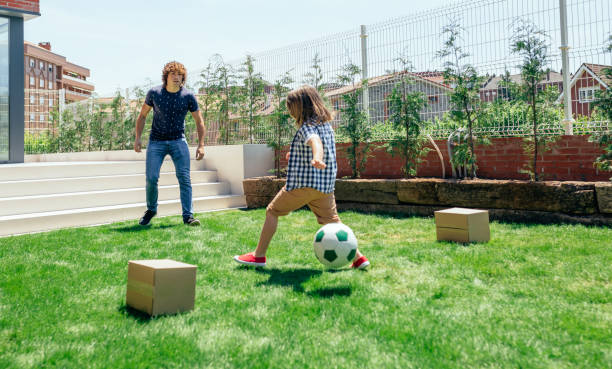 istock Father and son playing soccer 866660362