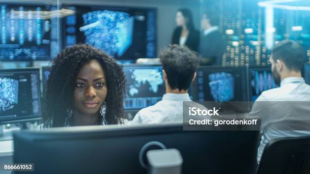 Female Computer Engineer Works On A Neural Network Artificial Intelligence Project With Her Multiethnic Team Of Specialist Office Has Multiple Screens Showing 3d Visualization Stock Photo - Download Image Now