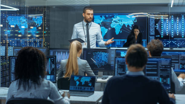 istock Chief Project Engineer Holds Briefing for a Team of Scientists that are Building Machine Learning System. Displays Show Working Model of Neural Network. 866661476
