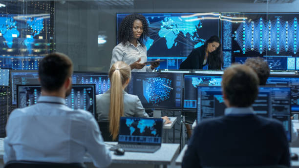 istock Chief Project Engineer Holds Briefing for a Team of Scientists that are Building Machine Learning System. Displays Show Working Model of Neural Network. 866661510