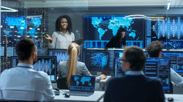 istock Chief Project Engineer Holds Briefing for a Team of Scientists that are Building Machine Learning System. Displays Show Working Model of Neural Network. 866661584