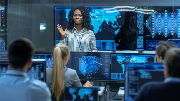 istock Chief Project Engineer Holds Briefing for a Team of Scientists that are Building Machine Learning System. Displays Show Working Model of Neural Network. 866661602