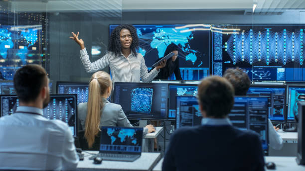 istock Chief Project Engineer Holds Briefing for a Team of Scientists that are Building Machine Learning System. Displays Show Working Model of Neural Network. 866661606