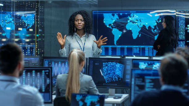 istock Chief Project Engineer Holds Briefing for a Team of Scientists that are Building Machine Learning System. Displays Show Working Model of Neural Network. 866661652