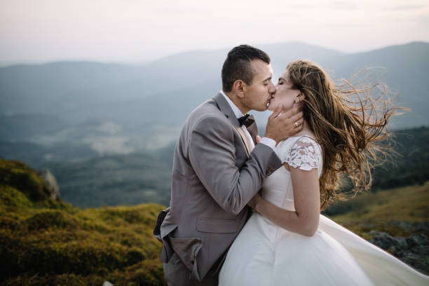istock Romantic couple standing together holding hands in the mountains 866679804