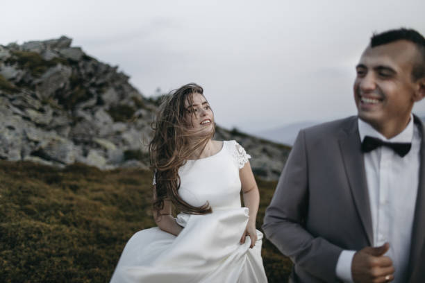 istock Romantic couple standing together holding hands in the mountains 866679980
