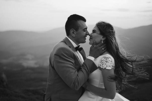 istock Romantic couple standing together holding hands in the mountains 866680246