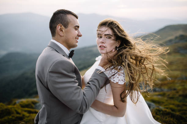 istock Romantic couple standing together holding hands in the mountains 866680358