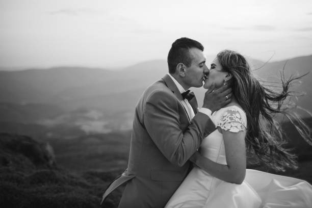 istock Romantic couple standing together holding hands in the mountains 866680420