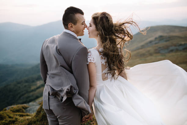 istock Romantic couple standing together holding hands in the mountains 866680448
