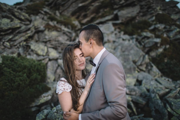 istock Romantic couple standing together holding hands in the mountains 866680662
