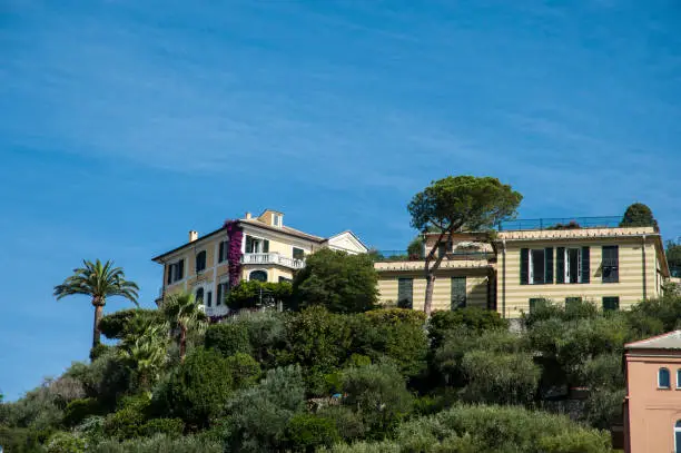 Photo of Portofino, Liguria Italia - watching the coast from the sea. View of the bay of Portofino, Villa Altachiara, one of the most popular village on the Italian Riviera.