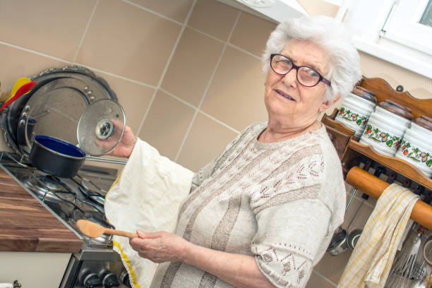 istock Smiling senior woman cooking in the kitchen. 866681244