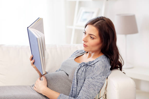 istock pregnant woman reading book at home 866683992