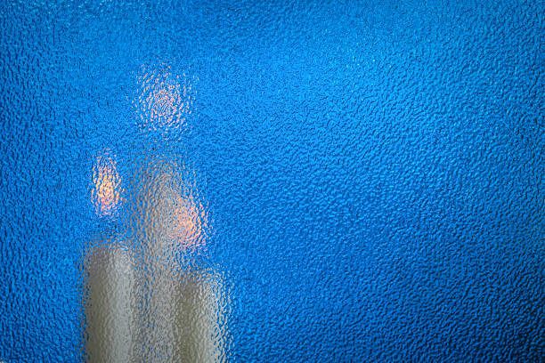 istock candle behind the glass, abstract background, soft focus 866684376