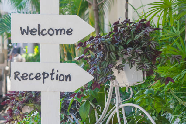 istock Welcome and Reception text on white label beside wildflowers in bicycle basket. 866685164