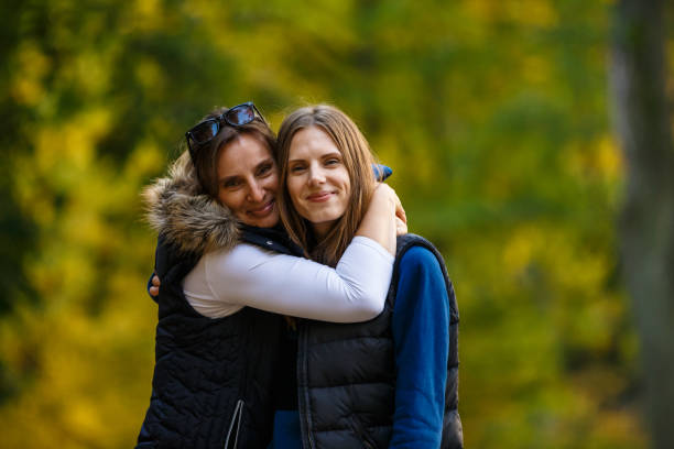 istock Two women walking in city park 866688140