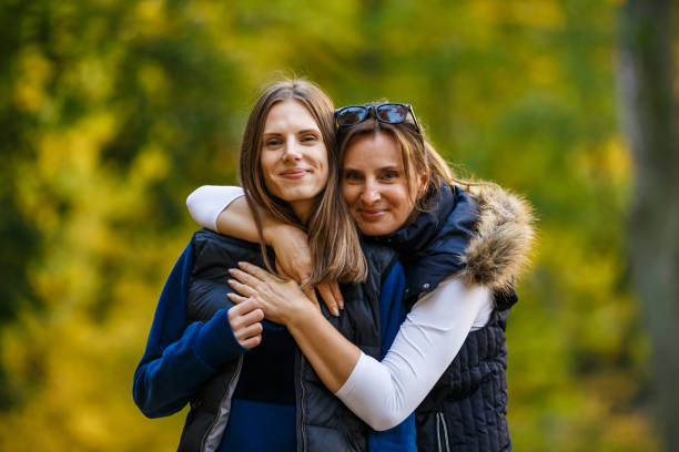 istock Two women walking in city park 866688228
