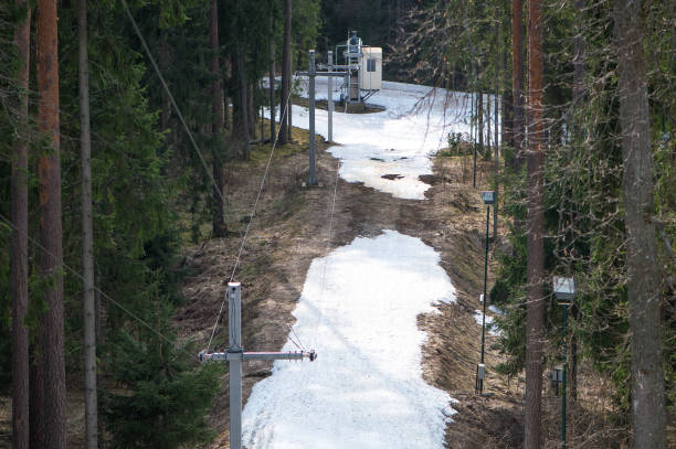 istock Skiing hoist in spring in mountains with half melted snow and surrounded with tall pine trees 866689100