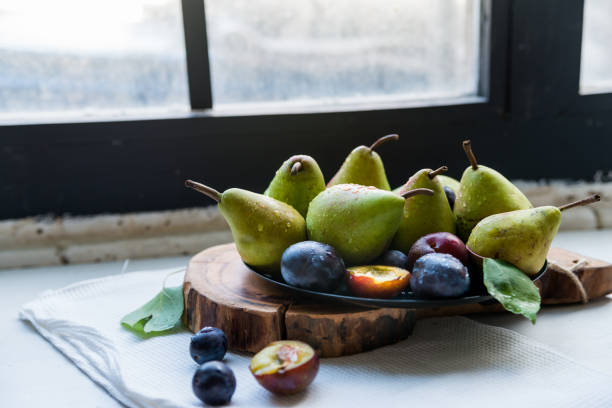 istock Studio shot plums and pears on plate heathy diet 866690106