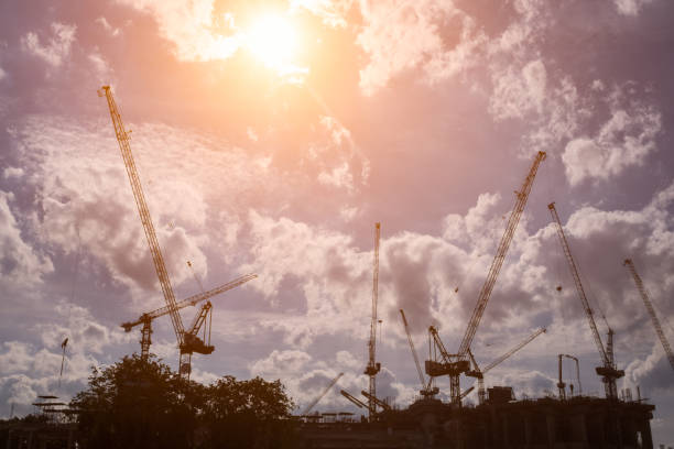 istock Silhouette of cranes at construction site. 866696476
