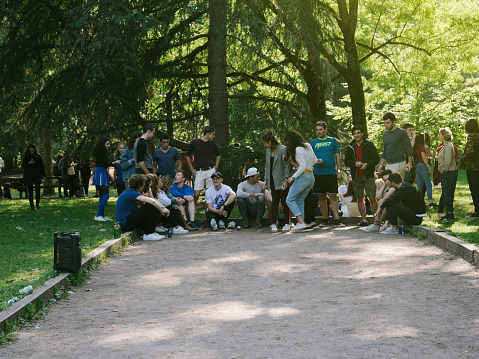 Strasbourg: Young people or students  at a team-building event playing petanque and drinking beer in a public park