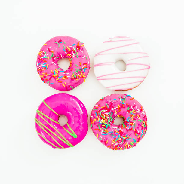 istock Colorful bright donuts on white background. Delicious food.  Flat lay, top view 866703012