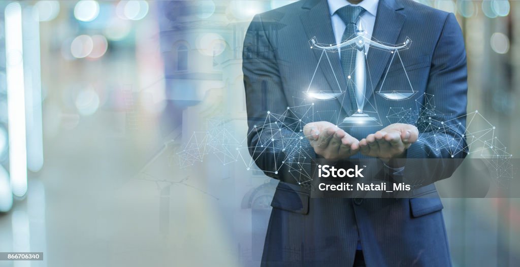 Scales of justice in the hands of a lawyer . Scales of justice in the hands of a lawyer on blurred background. Law Stock Photo