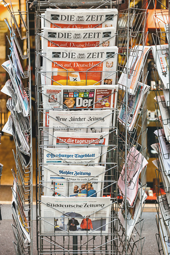 Paris: International and German newspaper at press kiosk with portrait of Angela Merkel after election in Germany for the Chancellor of Germany, the head of the federal government