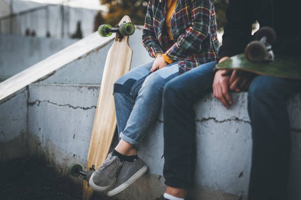 istock Skateboarders taking a rest in skate park 866710430