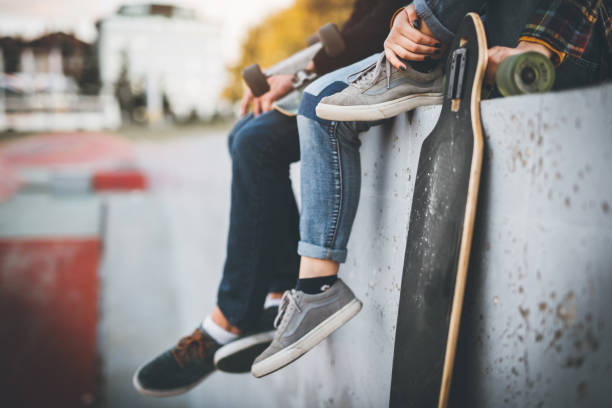 istock Skateboarders taking a rest in skate park 866710584