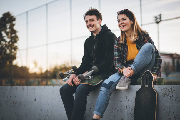 istock Skateboarders taking a rest in skate park 866710650